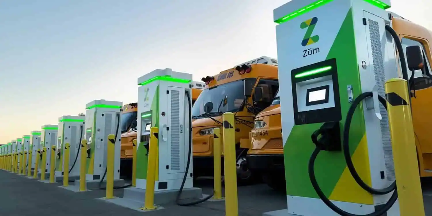 A row of electric buses parked side by side, showcasing their modern design and eco-friendly features.